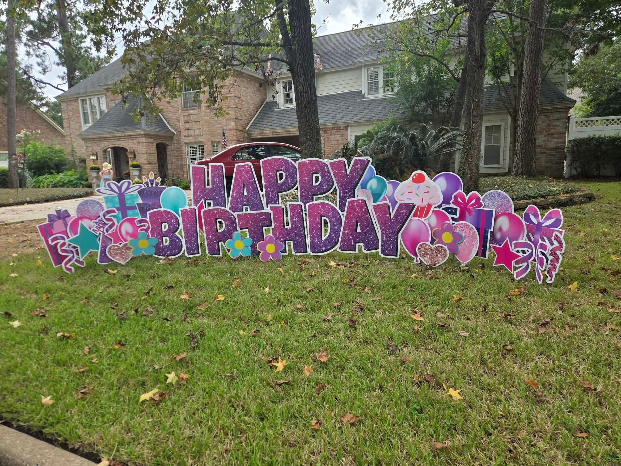 Colorful Happy Birthday yard sign on residential lawn